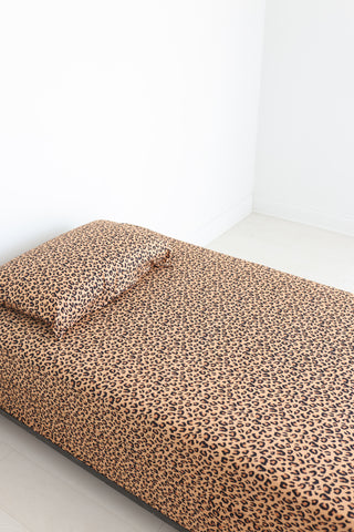 Twin sheet set with tan and black leopard print pattern, including fitted sheet, flat sheet, and pillowcase.