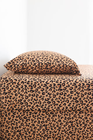 Twin sheet set with tan and black leopard print pattern, including fitted sheet, flat sheet, and pillowcase.