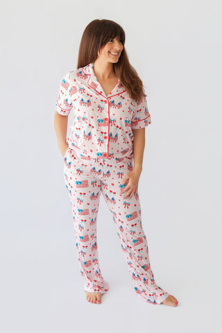 Women's two-piece pajama set with short sleeves and flare pants featuring American flags, bows, and cherries on white backgro