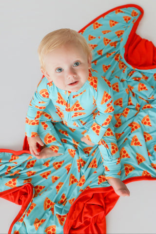 Infant wearing light blue romper with orange and red pizza slice pattern and red trim details.