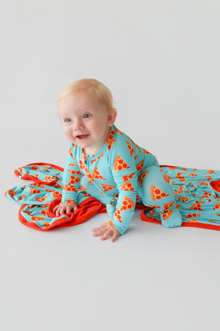 Infant wearing turquoise romper with red and yellow pizza slice print and red trim details.