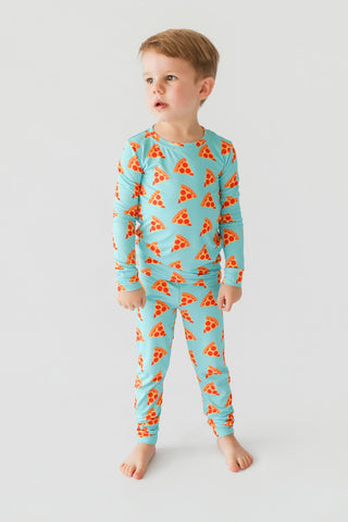 Toddler wearing turquoise long-sleeve shirt and matching pants with red pizza slice print throughout.