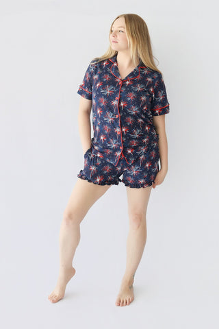 Women's short pajama set with navy base and red and white firework pattern throughout shirt and shorts.