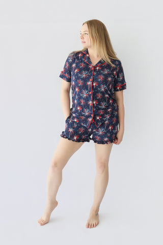Women's short pajama set with navy base and red, white firework pattern throughout shirt and shorts.