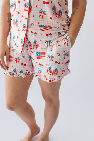 Women's short set with white gingham fabric printed with American flags, red bows, hearts, and stars in red and blue.