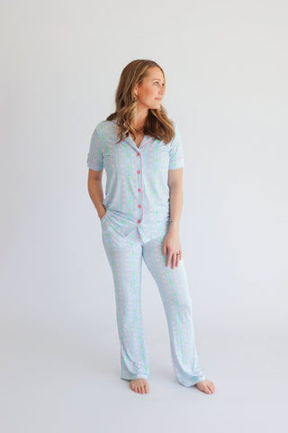 Women's two-piece pajama set with tulip print in blue and pink, featuring short-sleeve button-up shirt and flare pants.