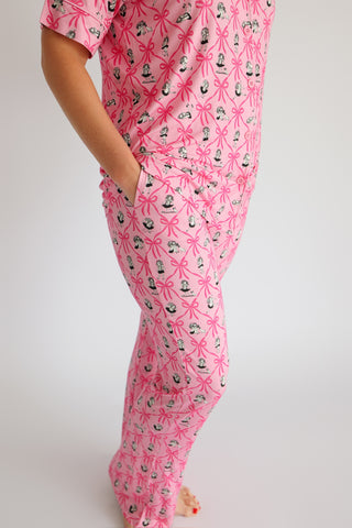 Pink flare pajama set with bow and figure print pattern, short sleeve top with matching wide-leg pants.