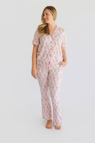 Women's two-piece pajama set with pink floral print, short sleeves, button-front shirt, and straight-leg pants.