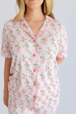 Women's short-sleeve pajama top with pink floral print and button front closure.