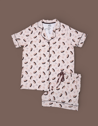 Women's two-piece short pajama set with martini glass and cocktail print on pale pink fabric.