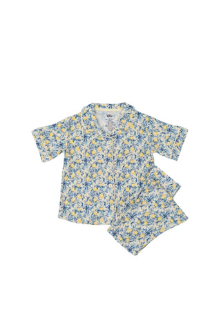 Girl's short-sleeve button-up shirt and flare pants set with blue and yellow citrus toile print.
