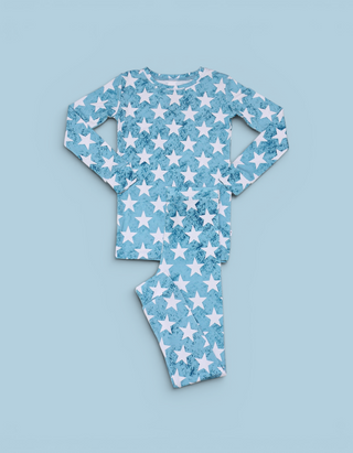 Blue pajama set with white stars and textured pattern throughout shirt and pants.