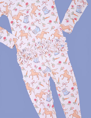 Lavender romper with horses, boots, flowers, and bows print, ruffle waistband detail.
